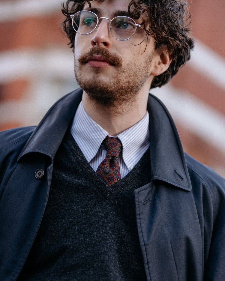 Man wears a v-neck Steadman with a shirt and tie